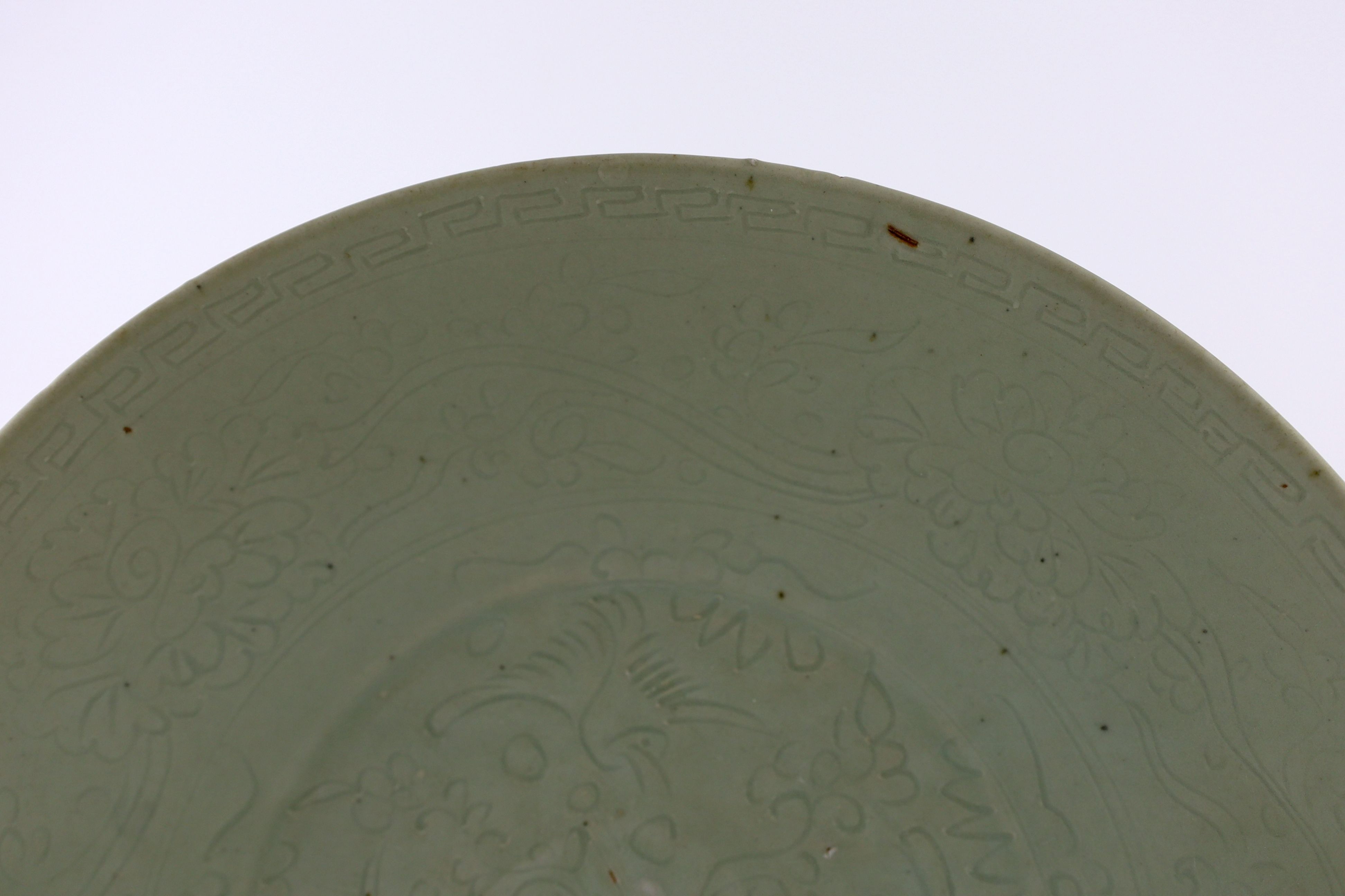 A Chinese celadon glazed sgraffito dish, Zhangzhou kilns, late 16th/early 17th century, 37cm diameter